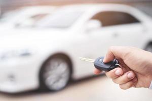 el vendedor está abriendo y cerrando la puerta del auto con la llave. por seguridad foto