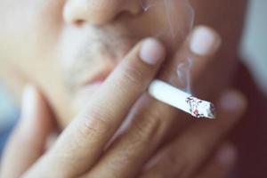 hombre fumando un cigarrillo. propagación del humo del cigarrillo. foto