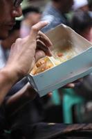 Magelang,Indonesai,2022-eating rice box with side dishes of noodles and corn rice photo