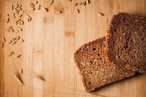 Sliced bread on a wooden table  with sunflower seeds photo