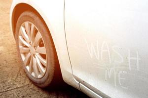 Close up of car dust with inscription on a dirty side door,  banner. photo