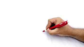 Man's hand holding pen and writing on virtual screen isolated on white background photo