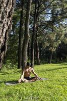 hispanic and latin man, meditating in the middle of a forest, receiving sun rays, brown skin, mexico photo