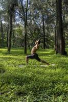 mexican man doing yoga and stretching in the forest, mexico photo