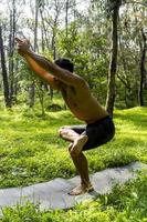 mexican man doing yoga and stretching in the forest, mexico photo