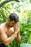 man seen up close, without shirt doing stretches on yoga mat, exercise, latin america photo