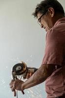latino man looking for tools in his toolbox, hispanic, with screwdriver in hand photo