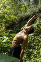 man seen up close, without shirt doing stretches on yoga mat, exercise, latin america photo