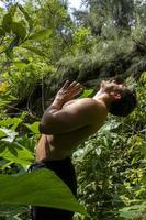 man seen up close, without shirt doing stretches on yoga mat, exercise, latin america photo