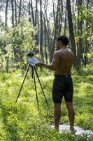 Guy with tablet making video blog on phone. Isolated person giving online classes. Man giving online classes with phone. photo