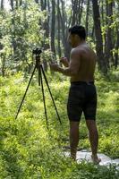 Guy with tablet making video blog on phone. Isolated person giving online classes. Man giving online classes with phone. photo