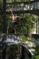 hispanic and latin man, meditating in the middle of a forest, receiving sun rays, brown skin, mexico photo