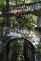 hombre hispano y latino, meditando en medio de un bosque, recibiendo rayos de sol, piel morena, méxico foto