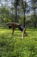 hispanic and latin man, meditating in the middle of a forest, receiving sun rays, brown skin, mexico photo