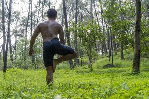 young man, doing yoga or reiki, in the forest very green vegetation, in mexico, guadalajara, bosque colomos, hispanic, photo