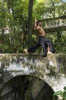 mexican man doing yoga and stretching in the forest, mexico photo