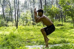 man seen up close, without shirt doing stretches on yoga mat, exercise, latin america photo