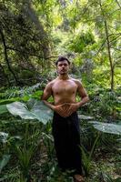 young man doing meditation on a stairway in a forest, mexico photo