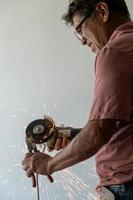 latino man looking for tools in his toolbox, hispanic, with screwdriver in hand photo