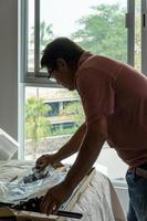 latino man looking for tools in his toolbox, hispanic, with screwdriver in hand photo