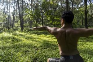 man seen up close, without shirt doing stretches on yoga mat, exercise, latin america photo