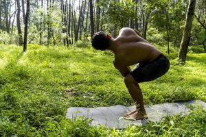 mexican man doing yoga and stretching in the forest, mexico photo