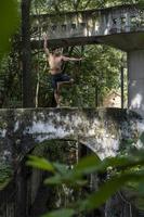 young man, doing yoga or reiki, in the forest very green vegetation, in mexico, guadalajara, bosque colomos, hispanic, photo