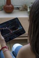 woman trading crypto currencies online and stocks photo