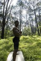 man seen up close, without shirt doing stretches on yoga mat, exercise, latin america photo