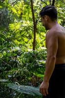 young man, doing yoga or reiki, in the forest very green vegetation, in mexico, guadalajara, bosque colomos, hispanic, photo