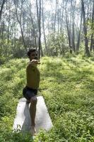 mexican man doing yoga and stretching in the forest, mexico photo