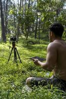 hispanic latino man giving class, while being recorded by a camera, holding ipad or tablet in his hand, mexico photo