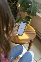 young latina woman on her cell phone, different activities, white screen, mockup or green screen photo