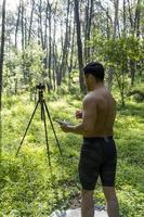 Guy with tablet making video blog on phone. Isolated person giving online classes. Man giving online classes with phone. photo