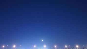 The moon night view with the bright moon in the dark sky at night photo