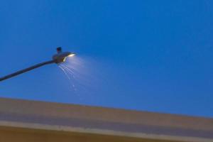 Glowing lantern in the dark with rain and drops Mexico. photo