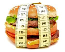 Fast food burger tied with measuring tape photo