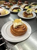 Bun with cream and nuts in a plate in a bakery photo