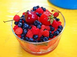 Mixed berry with natural yogurt in a glass bowl photo