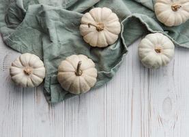 White pumpkins on a white wooden background photo