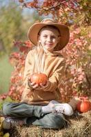 Girl in the hay with pumpkins photo