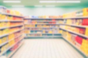 Abstract blurred background supermarket aisles with colorful shelves of merchandise. photo