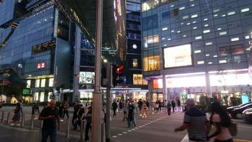 Downtown city intersection and crosswalk with pedestrians and cars video