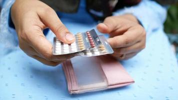 Close up of person holding multiple pill packs and carrying case video