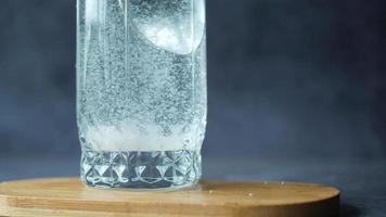 Side view of powder being stirred into and dissolved in water video