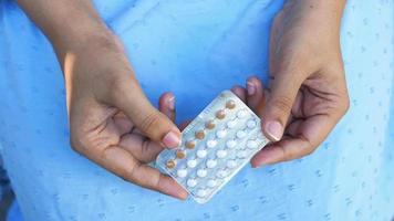 Close up of hands holding birth control pills video