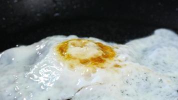 Fried egg browned in a skillet close up video