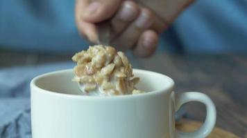 Close up of cereal in a mug stirred with a spoon video