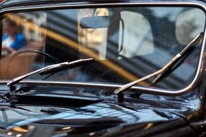 Retro car windscreen with a windshields closeup. Part of black vintage car photo