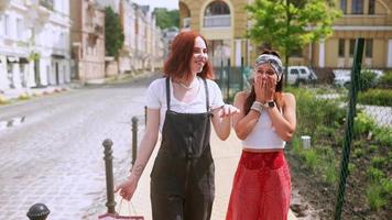 Women friends talking and walking on the sidewalk video